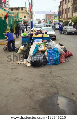 LIMA, PERU - JULY 27, 2013: Pile of garbage waiting to be picked up by the garbage truck at the entrance of the market Mercado No. 2 de Surquillo on July 27, 2013 in Surquillo, Lima, Peru.