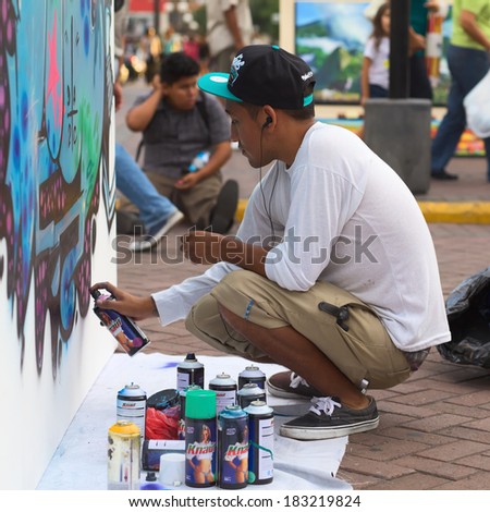 LIMA, PERU - MARCH 3, 2012: Unidentified young man spraying a wall on the Latir Latino, the first Latin-American Street Art Festival on March 3, 2012 in Miraflores, Lima, Peru.