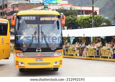 BANOS, ECUADOR - FEBRUARY 22, 2014: Bus of the Expreso Banos transportation company leaving the bus terminal on February 22, 2014 in Banos, Ecuador.