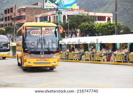 BANOS, ECUADOR - FEBRUARY 22, 2014: Bus of the Expreso Banos transportation company in the bus terminal with a row of small sweets stands in the back on February 22, 2014 in Banos, Ecuador.