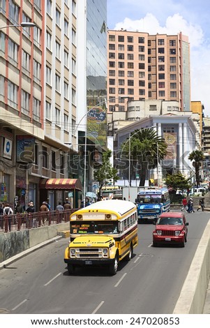 LA PAZ, BOLIVIA - NOVEMBER 28, 2014: Old Chevrolet buses used for public transport and a new Jeep on Villazon Avenue with the Plaza del Estudiante in the back on November 28, 2014 in La Paz, Bolivia