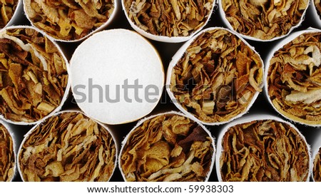 Cigarette with filter in between ones without filter as background