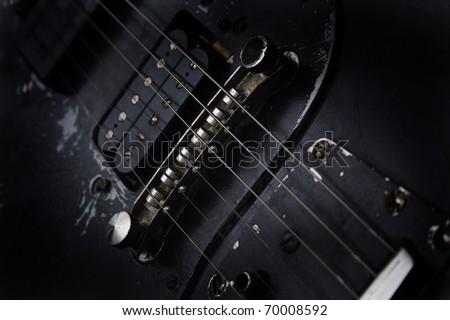 detail of old black guitar
