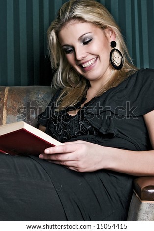 Beautiful blond woman reading a book
