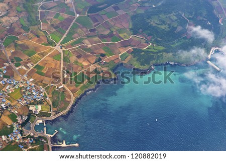 aerial view on the cultivated land and on the suburbs urban along marine coast