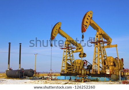 Oil and gas industry. Work of oil pump jack on a field.