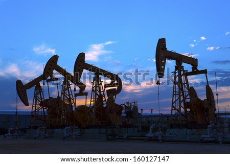 Oil pump oil rig in the sunset background for design