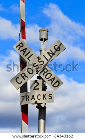 US railroad Crossing sign in front of blue sky