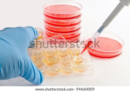 Handling of cell culture plates for cultivation of cells in life science research laboratory