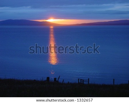 Sunset over Scapa Flow, Orkney, below overcast cloud. Hoy in the distance