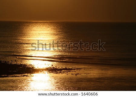 Sunshine low over Spey Bay, the mouth of the River Spey in Scotland