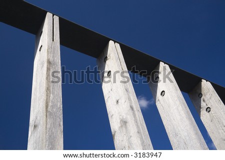 Framework of wood planks against a deep blue sky