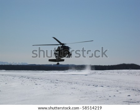 UH-60 Helicopter landing in the snow, Alaska
