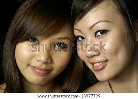 Two happy asian lady friends