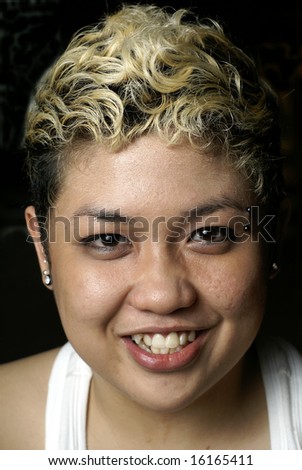Happy malay lady with piercing and blonde hair