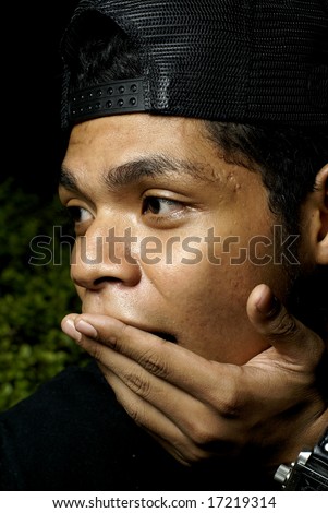 Asian malay man surprised and holding hand to mouth