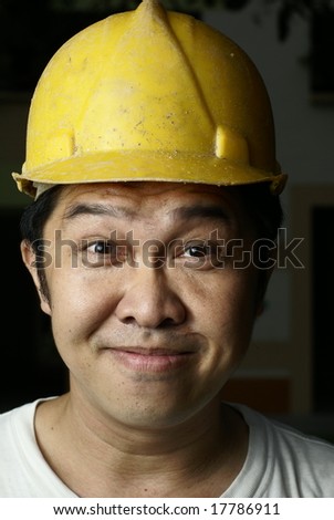 Smiling asian construction worker