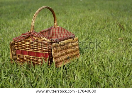 Picnic hamper basket in field