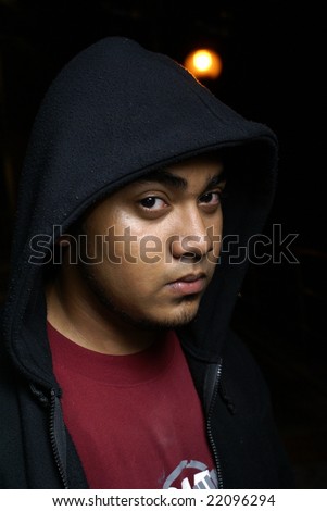 Asian man with hood portrait at night