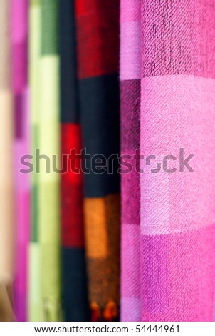 Colorful cashmere shawls hanging together background