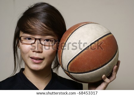 stock photo Youthful asian chinese teen girl with basketball smiling and 
