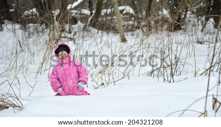 Little winter girl in fairy ice forest running