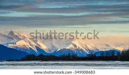Chilkat River and Mountains in snow on a sunrise. Alaska.USA