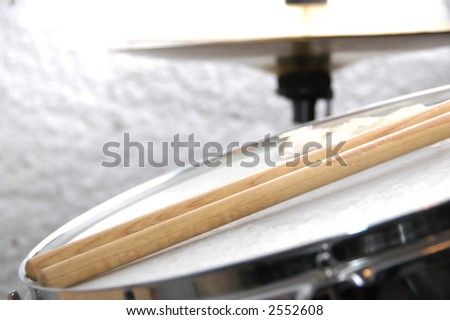 Snare drum and Sticks with hihat in background