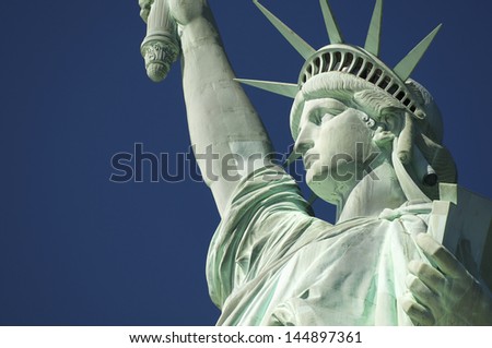 Close-up Portrait of Statue of Liberty Bright Blue Sky with Book and Crown