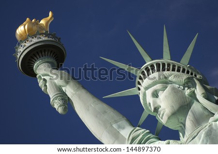 Close-up Portrait of Statue of Liberty Bright Blue Sky with Torch and Crown