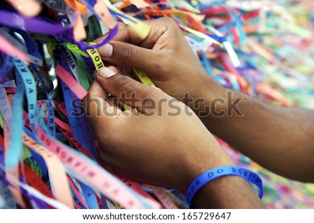 Brazilian hands tie on Lembranca do Senhor Bonfim da Bahia wish ribbons Salvador Brazil