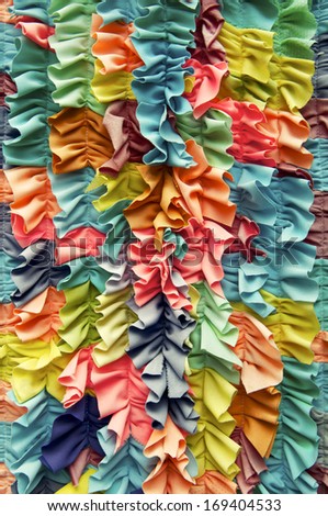 Bright colorful ruffled fabric background close-up