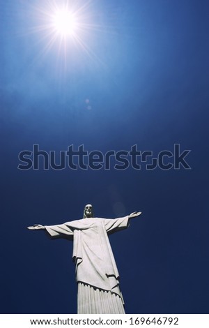 Corcovado Christ the Redeemer statue standing under bright tropical sun blue sky Rio de Janeiro Brazil