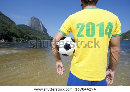 Brazilian Soccer Player In 2014 Shirt Standing With Football At Sugarloaf Pao De Acucar In Rio De Janeiro Brazil