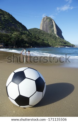 Football soccer ball on Red Beach at the foot of Sugarloaf Mountain Rio de Janeiro Brazil