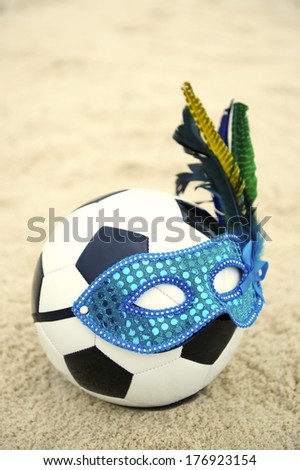 The best of Brazilian culture comes together in a football soccer ball wearing carnival mask on the beach