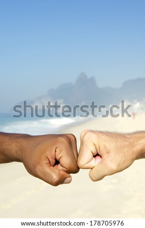 Fist bump Brazilian diversity interracial hands cooperating together Ipanema Beach Rio de Janeiro Brazil
