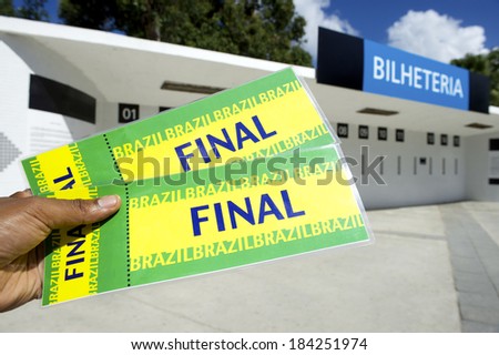 Soccer fan holding two Brazil final tickets outside the ticket window