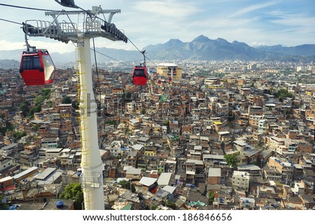 Red cable cars travel above Rio de Janeiro favela Complexo Alemao Red cable cars travel above Rio de Janeiro favela Complexo Alemao