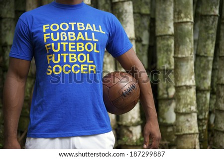 Brazilian soccer player wears international football shirt against a tropical bamboo forest background