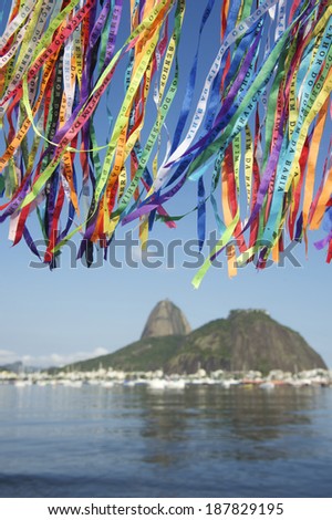 Colorful Brazilian wish ribbons fluttering above scenic view of Sugarloaf Pao de Acucar Mountain Rio Brazil