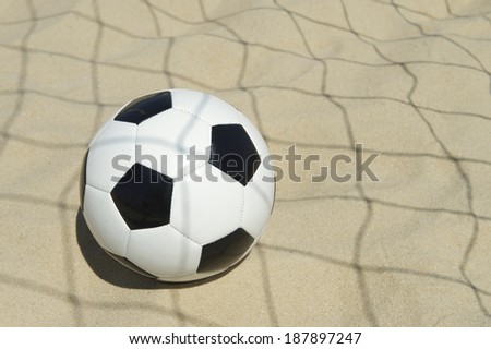 Soccer goal ball in shadow of football net on the beach in Rio de Janeiro Brazil