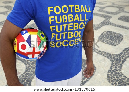 Brazilian soccer player wears international football shirt carrying a ball with World Cup team flags