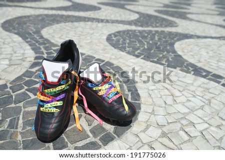 Good luck soccer football boots soccer cleats laced with Brazilian wish ribbons on the Copacabana Beach sidewalk Rio de Janeiro