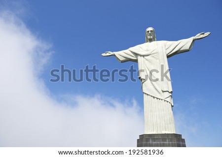 RIO DE JANEIRO, BRAZIL - OCTOBER 20, 2013: Statue of Christ the Redeemer at Corcovado stands on its base against misty blue sky.