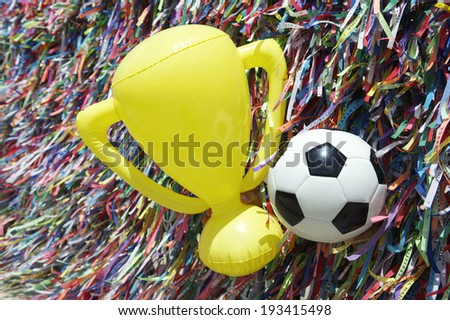 Good luck football soccer ball and championship trophy at wall of Brazilian wish ribbons at the Bonfim church in Salvador Bahia Brazil
