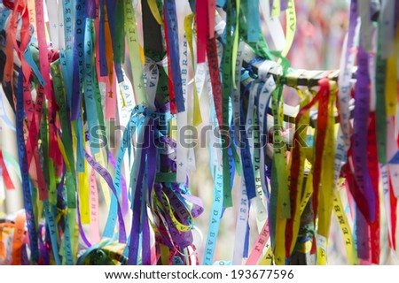 Colorful Brazilian wish ribbons fluttering in the wind on a window frame at the Bonfim Church Salvador Bahia Brazil