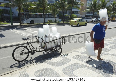 RIO DE JANEIRO, BRAZIL - CIRCA MARCH, 2013: Man delivers bags of fresh ice from a cart to beach stalls along the Ipanema Beach boardwalk.
