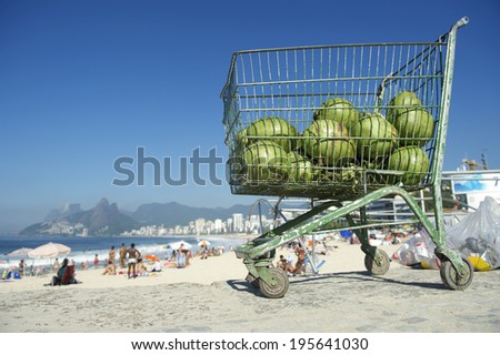 Shopping cart full of fresh green Brazilian coco verde coconuts sitting in the sun at Ipanema Beach Rio de Janeiro Brazil