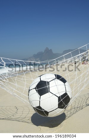 Soccer ball relaxing in football goal net hammock on Ipanema Beach in Rio de Janeiro Brazil